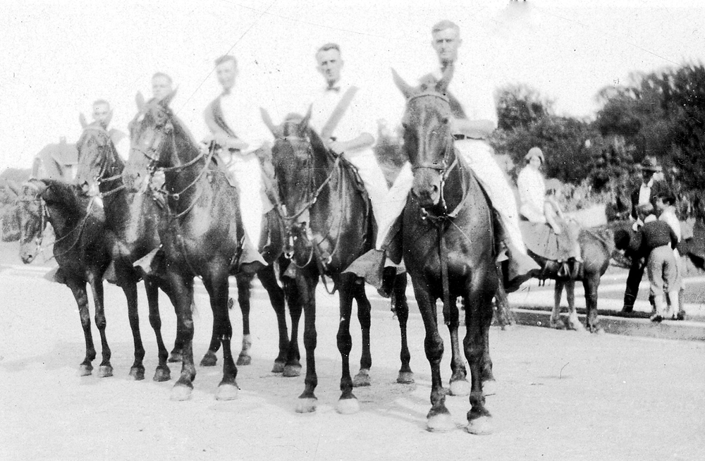 Amos Reeder on horseback (on the right) for a parade, circa 1920